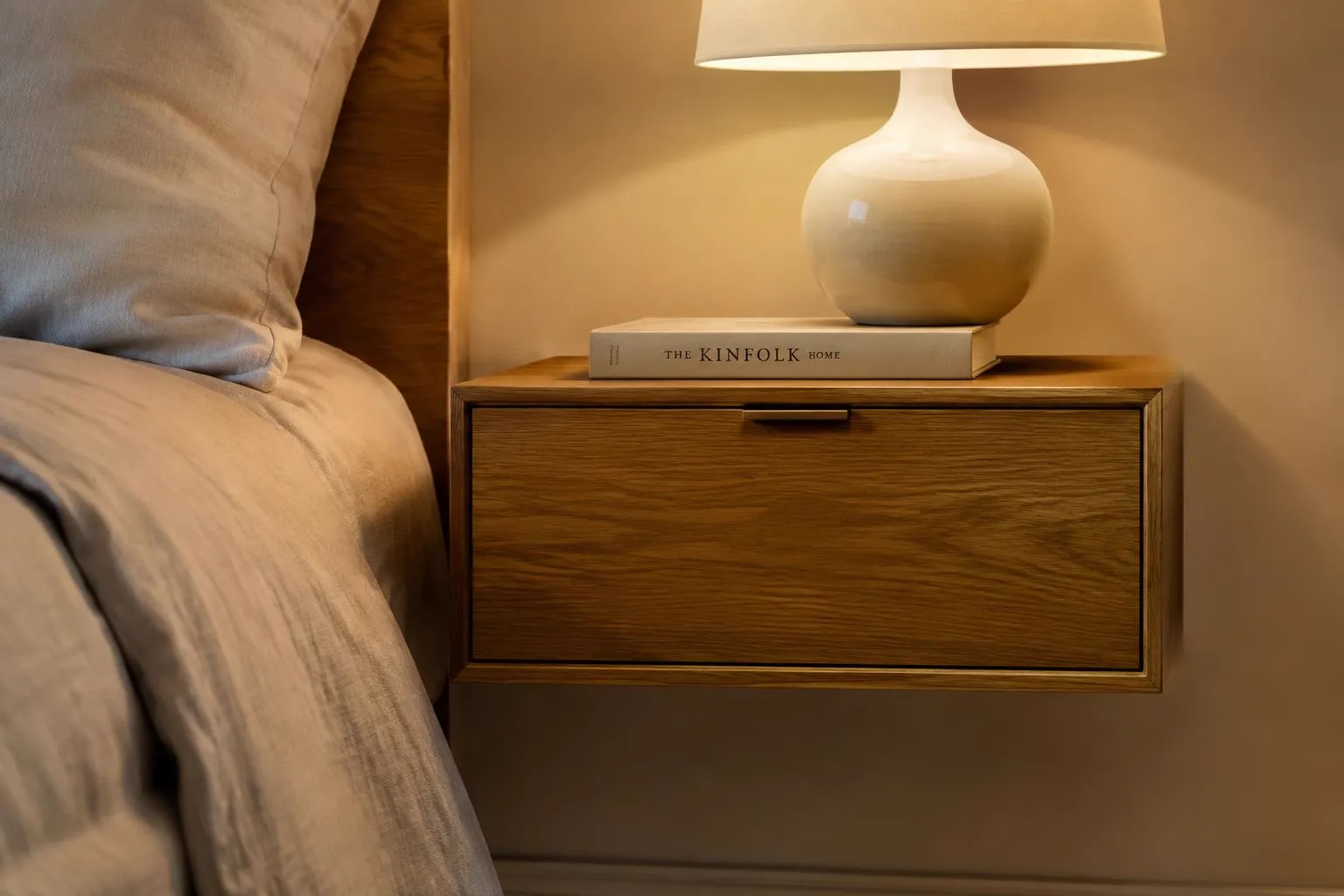 Floating oak nightstand with a ceramic lamp